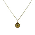 The image shows a delicate pendant necklace with a small, round compass charm about half an inch wide, finished in warm gold‑toned brass. The smooth compass face has lightly engraved directional markings and hangs from a slim, gold‑plated brass cable chain with a small lobster clasp.