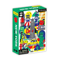 Product title: New York City Mini Puzzle 
A small, brightly colored puzzle box shows playful illustrations of New York City icons, including a water tower, the Empire State Building, the Statue of Liberty, a yellow taxi, and other classic city sights. The view is at an angle depicting the spine and cover.