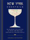 Book cover of New York Cocktails by Amanda Schuster, featuring a vibrant blue background, ornate gold Art Deco framing, and an elegant cocktail glass filled with a stylized New York City map in pale yellow, red, blue, and green.