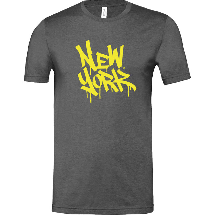 This T‑shirt features the words ‘New York’ in large graffiti‑style yellow letters that appear to drip like wet paint against a gunmetal grey background. Made from a soft cotton‑poly blend, it’s both comfortable and stylish.