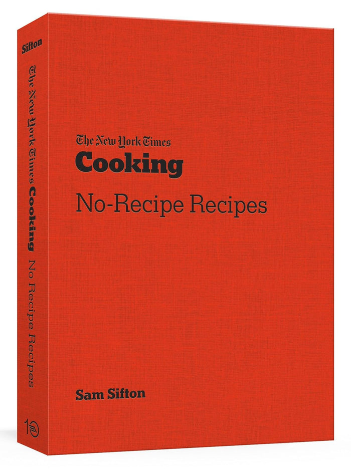 Book title: New York Times Cooking: No Recipe Recipes (A Cookbook). The hard-cover cookbook, features a matte, fiery-red cover with bold black text.