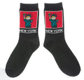 NYC Cartoon Statue of Liberty Socks 
These black crew socks feature a soft, woven cartoon image of the Statue of Liberty. On the ankle is a square red panel outlined in white, containing a friendly green Lady Liberty with small orange details in her hair and torch flame. Below the panel, “NEW YORK” appears in large, bold lettering in white. The socks feel smooth and flexible, made for comfortable everyday wear with playful New York character.