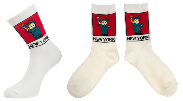 NYC Cartoon Statue of Liberty Socks 
These white crew socks feature a soft, woven cartoon image of the Statue of Liberty. On the ankle is a square red panel outlined in black, containing a friendly green Lady Liberty with small orange details in her hair and torch flame. Below the panel, “NEW YORK” appears in large, bold lettering in black. The socks feel smooth and flexible, made for comfortable everyday wear with playful New York character.