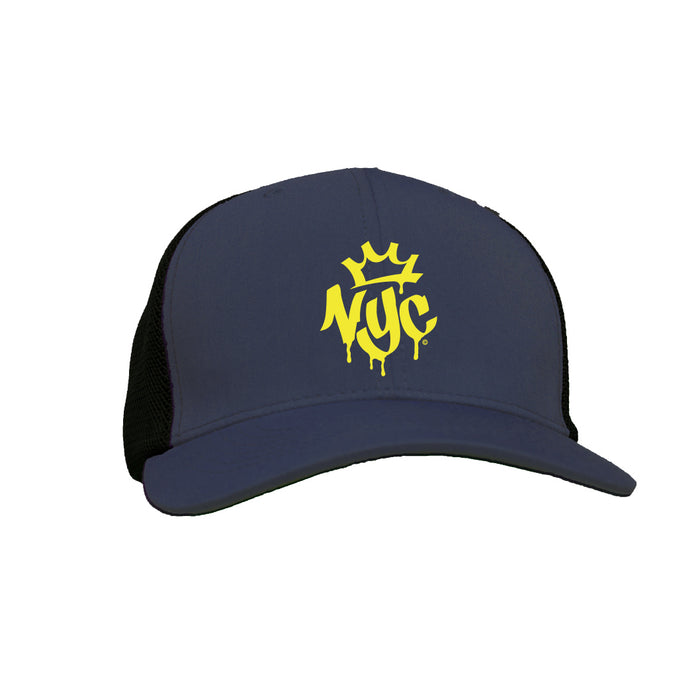 This cap is gunmetal grey and features the letters ‘NYC’ in bold, graffiti‑style bright yellow text across the front. A small whimsical crown sits above the lettering, and the spray‑paint look of the design stands out against the darker background.