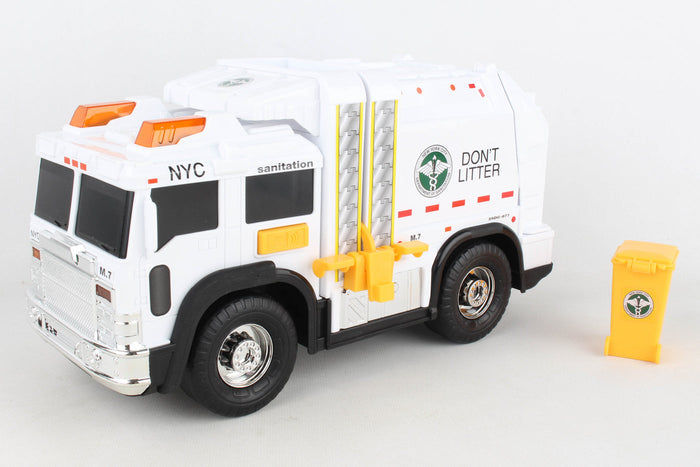 The truck is large and boxy, with a bright white body accented in yellow and dark green. It has black wheels and a solid, heavy feel. Along the sides are NYC Sanitation logos, including bold lettering that reads “Don’t Litter” and strong striping. The rear has a movable loading area for trash, with small details suggesting lights on the front and roof. It includes a yellow trash can. Overall, it feels sturdy and industrial, like a real New York sanitation truck made small.