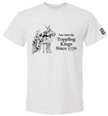 A soft white T‑shirt with bold black graphics on the front. The design includes large lettering that reads “New York City Toppling Kings Since 1776,” above and below a high‑contrast scene of a crowd pulling down a statue with ropes. The fabric feels smooth and comfortable. On the left sleeve, there is a small square black‑and‑white logo for the Museum of the City of New York.