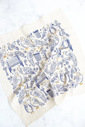 Park Pigeon Pals Screen Printed Tea Towel: This tea towel features a repeating blue and yellow line‑drawing pattern on a white background, filled with small pigeon characters in charming park scenes—perched on a bench, splashing in a puddle, and wandering by a trash can.