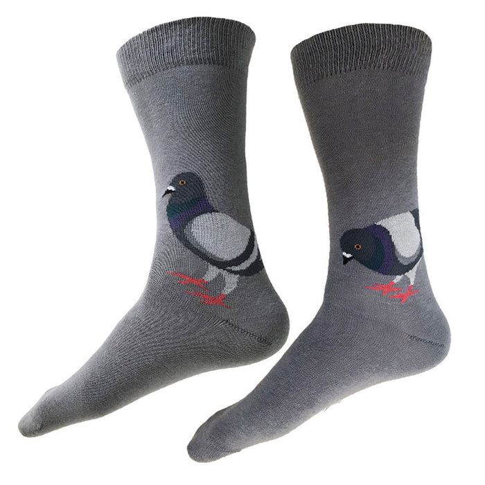 A pair of knit cotton socks featuring an illustration by artist Kate Williamson. The design shows two pigeons drawn in a simple, elegant style, with rounded black grey bodies, deep green and purple necks, and lighter grey wings. The pigeons have black beaks and yellow irises with black centers for visual contrast, along with red legs and small claws. One pigeon stands upright and alert, while the other leans forward to snack, making the figures easy to recognize through clear shapes and strong contrast.