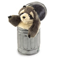 The puppet shows a gray raccoon with a black mask around its eyes, small rounded ears, and a striped black‑and‑gray tail. Its front paws are raised, as if rummaging. The raccoon sits inside a silver garbage can with a ridged metal texture. The overall look is playful and cartoon‑like, easy to recognize by touch and shape.