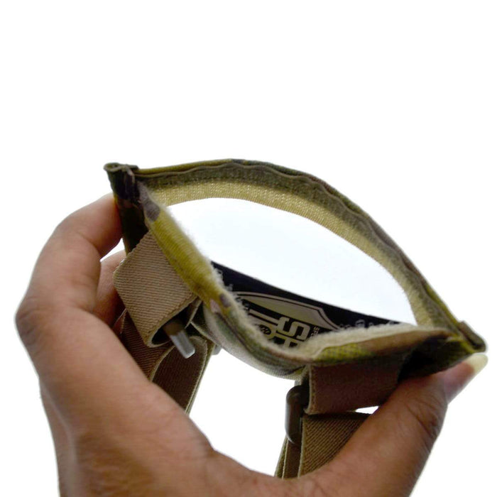 A hand holds a small, open pouch with a Velcro closure, revealing the interior – reminiscent of a Raine Military ID Badge Armband Holder with Two Straps (SPID-1090) designed for durability and functionality.