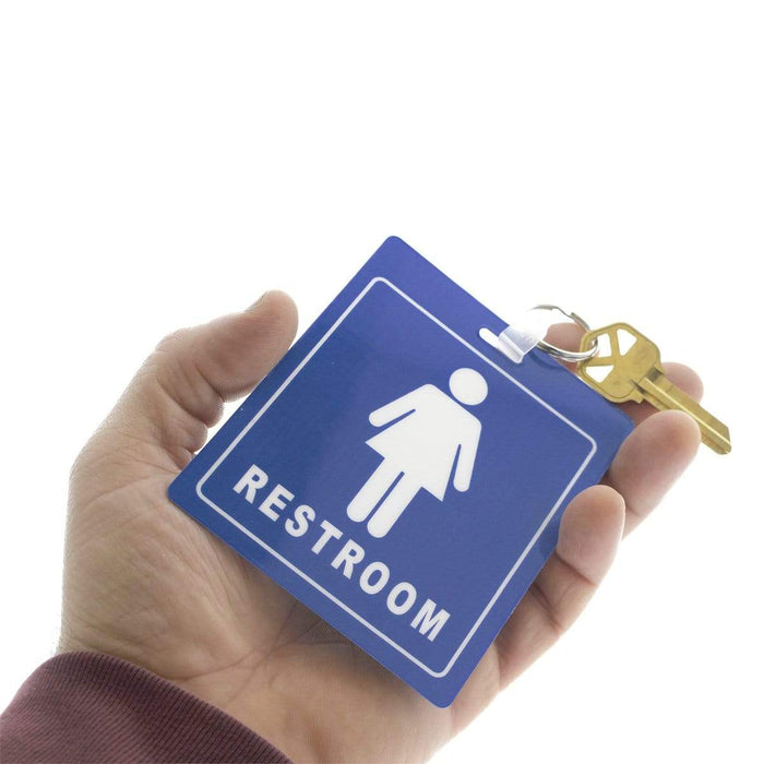 A hand holding a Restroom Pass Keychain - Bathroom Tag with Key Chain Ring - Heavy Duty Large Passes for Men and Women Restrooms with Key Holder (Sold in 2 Pack) (SPID-9830-Blue) featuring a blue sign with a female symbol.