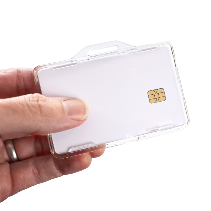 A hand holds the Specialist ID Dual Sided RFID Blocking Badge Holder (SPID-1760), a heavy-duty smart card protector for CAC, TWIC, PIV, HSPD-12 & secure ID badges featuring 13.56 MHz RFID shielding for added security.