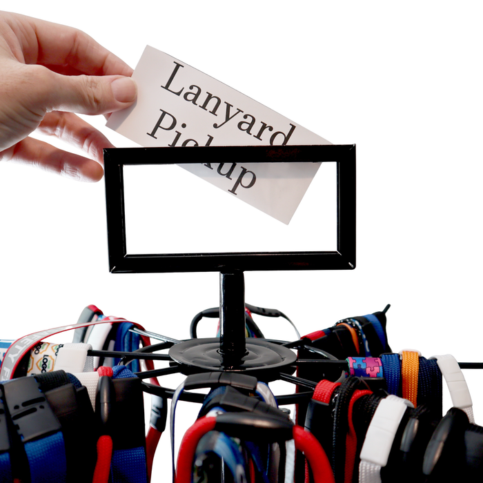 Lanyard pickup sign inserted into rotating lanyard display stand