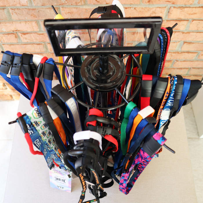 Close-up of colorful lanyards hanging on rotating display stand