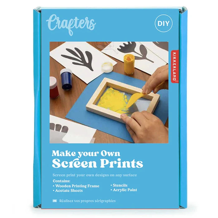 Box with photo of hands using a small screen printing kit on a blue background background.