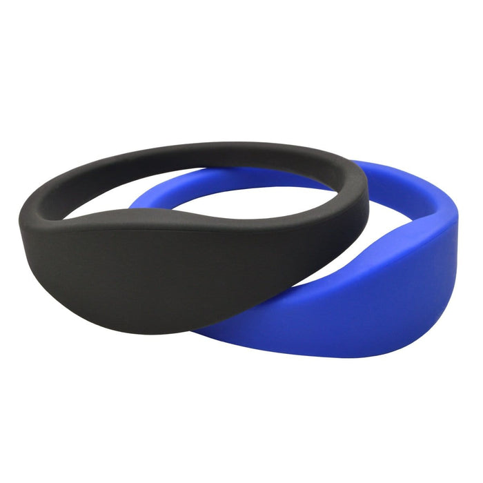 Two SPID UBand Proximity Silicone WristBands, one black and one blue, each equipped with a 125 kHz proximity chip, are overlapped and displayed against a white background. Sold by Specialist ID.