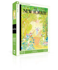 Springtime New Yorker Puzzle — 
The box is a medium‑sized rectangle with smooth, flat surfaces and no raised texture. The front shows a detailed illustration printed completely flat. It depicts a lively city sidewalk filled with blooming flowers, leafy trees, and a woman pausing to admire her garden work. Small figures and buildings line the background, creating a busy springtime street scene. The colors are bright green, blue, pink and orange.