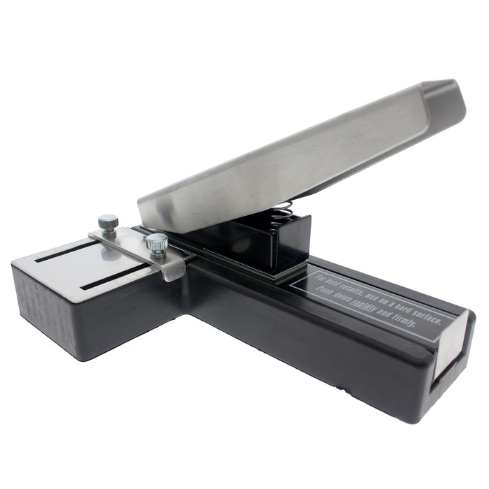 A heavy-duty Stapler-Style Slot Punch With Adjustable Guide (P/N SPID-9750) handheld device, featuring a metal and plastic build with a lever mechanism in a partially open position. The slot punch includes instructional text on its surface, two adjustable knobs on the side, and boasts a non-slip rubber base for stable operation.