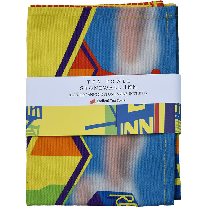 The image depicts the Stonewall Tea Towel, presented folded and wrapped with a printed belly band.