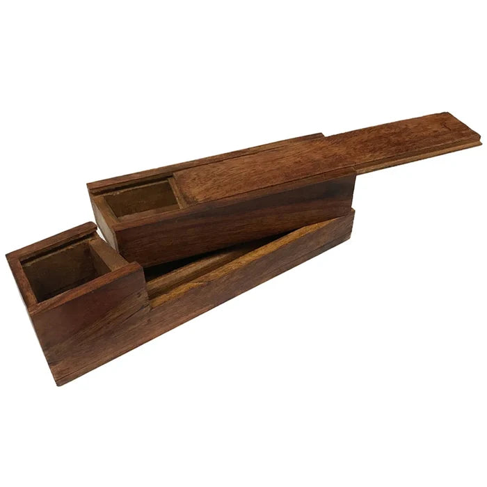 Rectangular traveling writing instrument box made of smooth teak wood, shown open. The warm brown wood has visible grain and a simple, sturdy construction. The box is shaped to hold a square glass inkwell and a wooden nib pen (not included), designed to keep writing tools neatly contained and easy to carry. The overall feel is solid, refined, and reminiscent of historic travel writing kits.