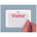 A hand is holding a white badge with the word "Visitor" in red letters, placed against a blue background. The badge is attached using a Reusable 4 X 3 Cardbacker Badge Back, Box of 500 (P/N 05661), ensuring it stays securely in place.