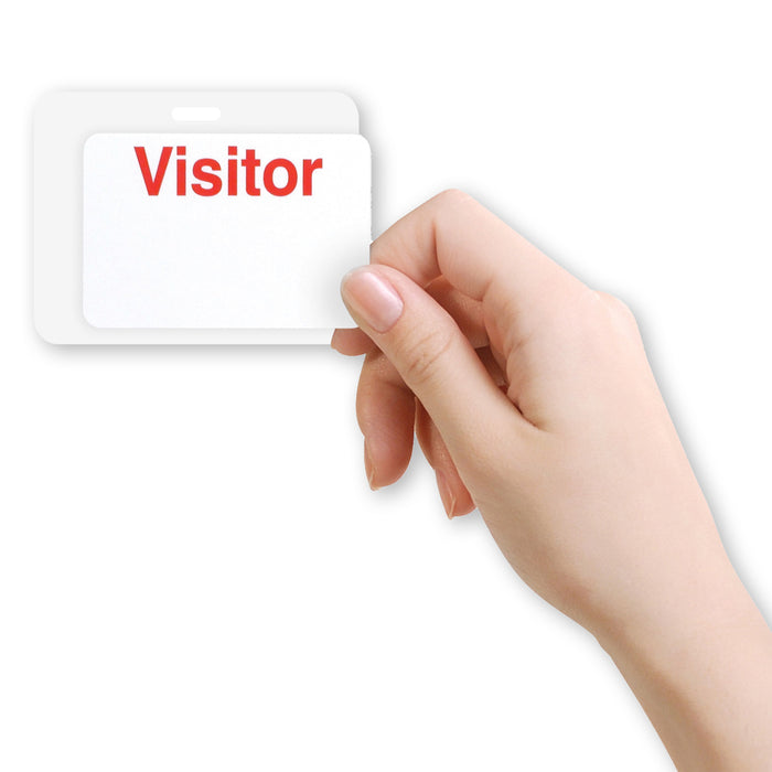 A hand holding an ID badge with the word "Visitor" in red text, showcasing a Reusable 4 X 3 Cardbacker Badge Back, Box of 500 (P/N 05661).