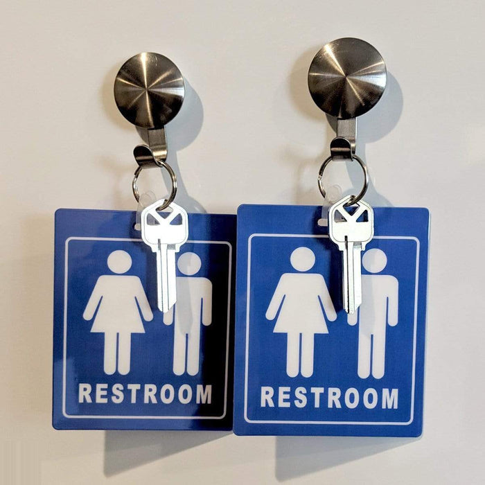 Two Unisex Restroom Pass Keychains - Bathroom Tag with Key Chain Ring - Heavy Duty Large Passes for Unisex & Family Restrooms with Key Holder (Sold in 2 Pack) (SPID-9840-Blue), each hanging from metal hooks.